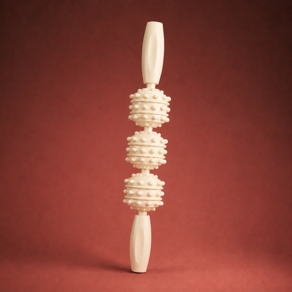 Cream muscle roller stick standing vertical on warm crimson studio backdrop